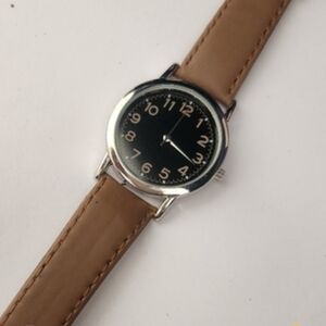 Calvin Hill Silver Quartz Watch With A Tan Strap, Black Face and Tan Numerals.